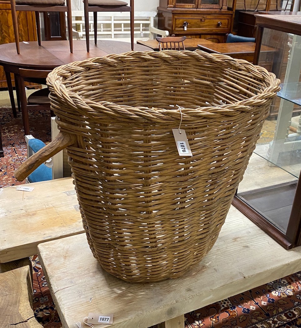 A rustic wicker grape hod, width 65cm, height 63cm